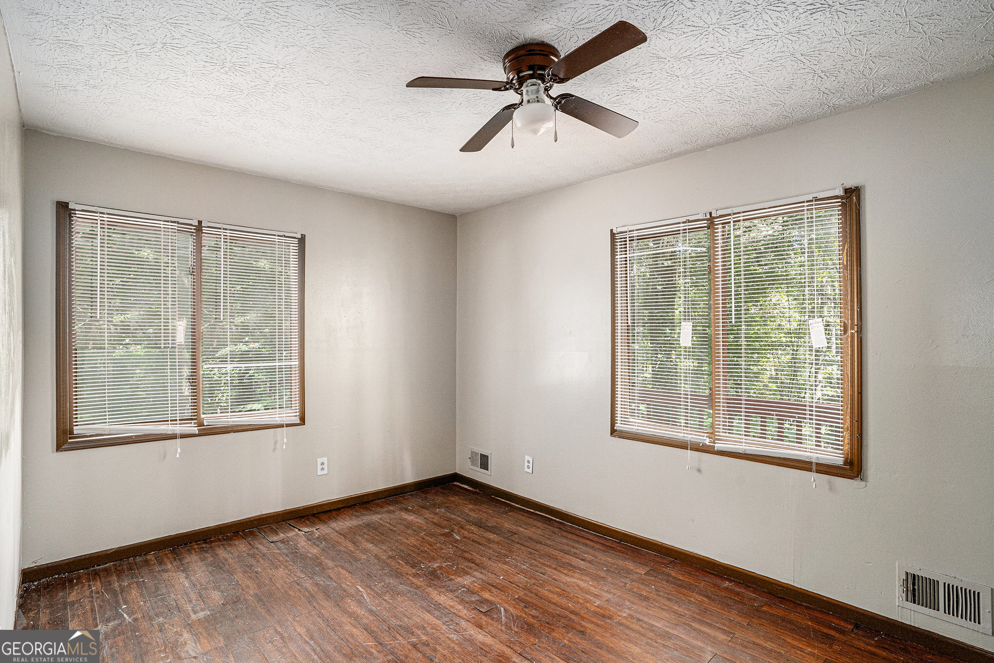 1341 Bethaven Road Riverdale, GA 30296 - Photo 15 of 18 a view of an empty room with a window and wooden floor