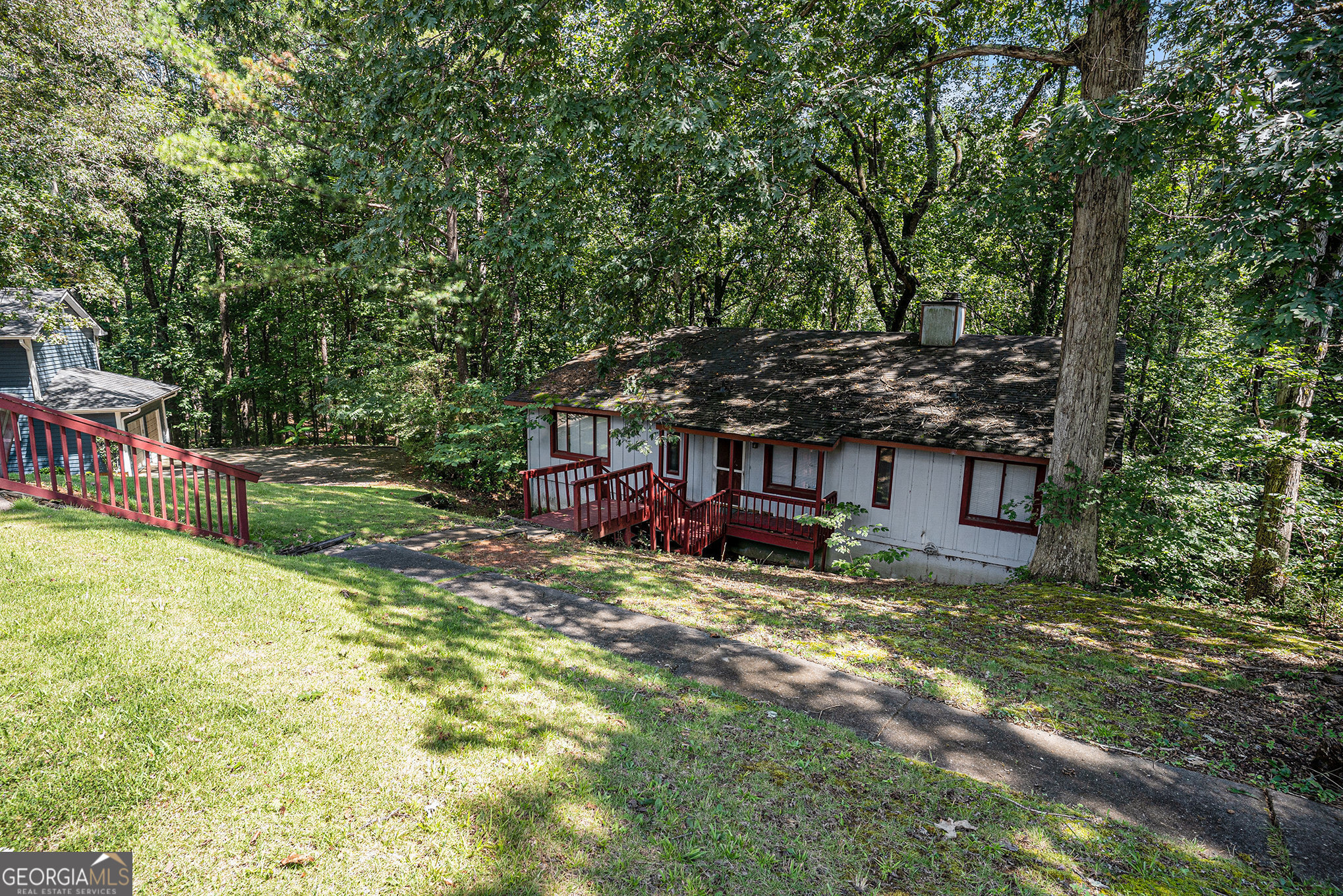 1341 Bethaven Road Riverdale, GA 30296 - Photo 2 of 18 a view of a backyard with a table and chairs under an umbrella