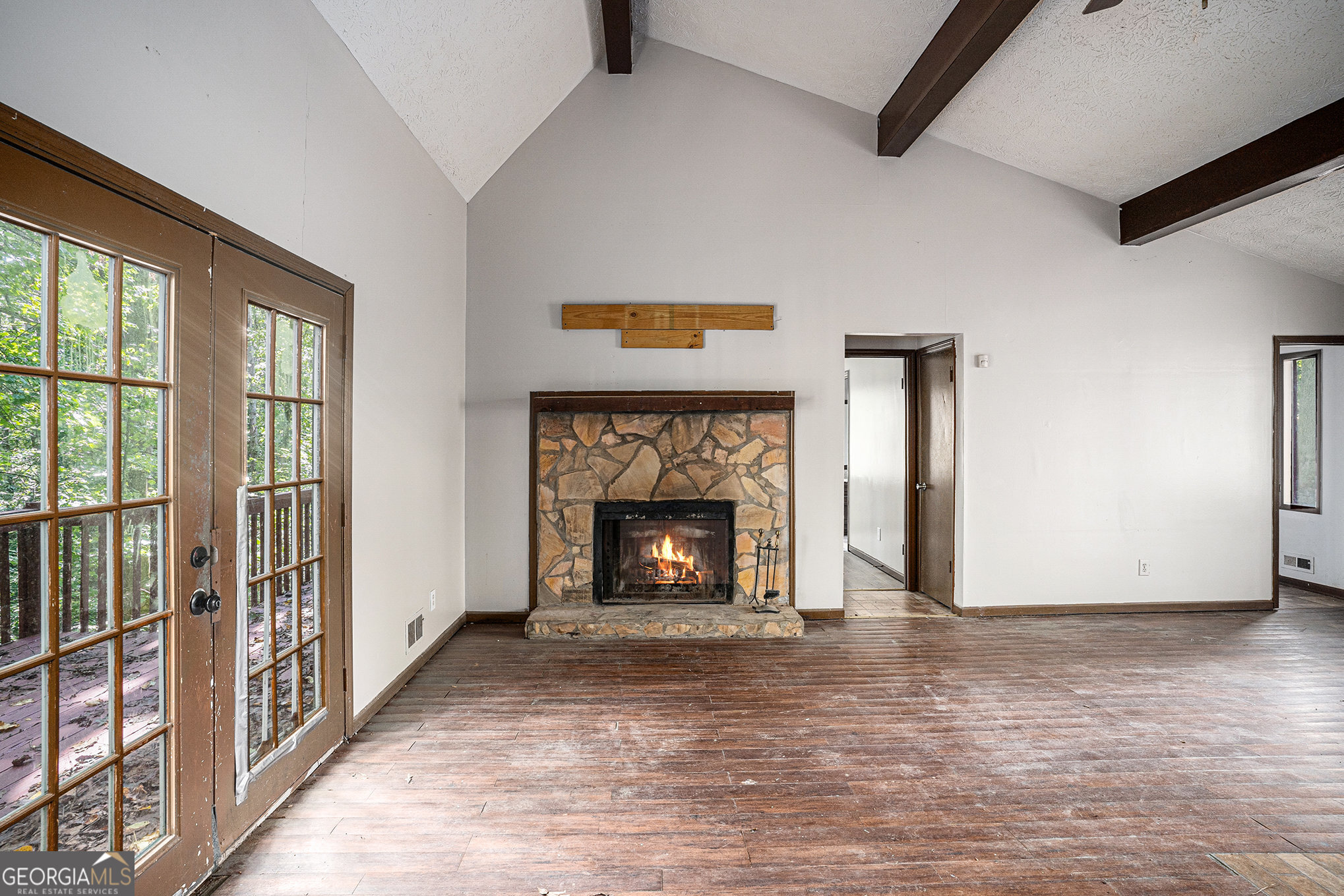 1341 Bethaven Road Riverdale, GA 30296 - Photo 4 of 18 a view of an empty room with wooden floor fireplace and a window