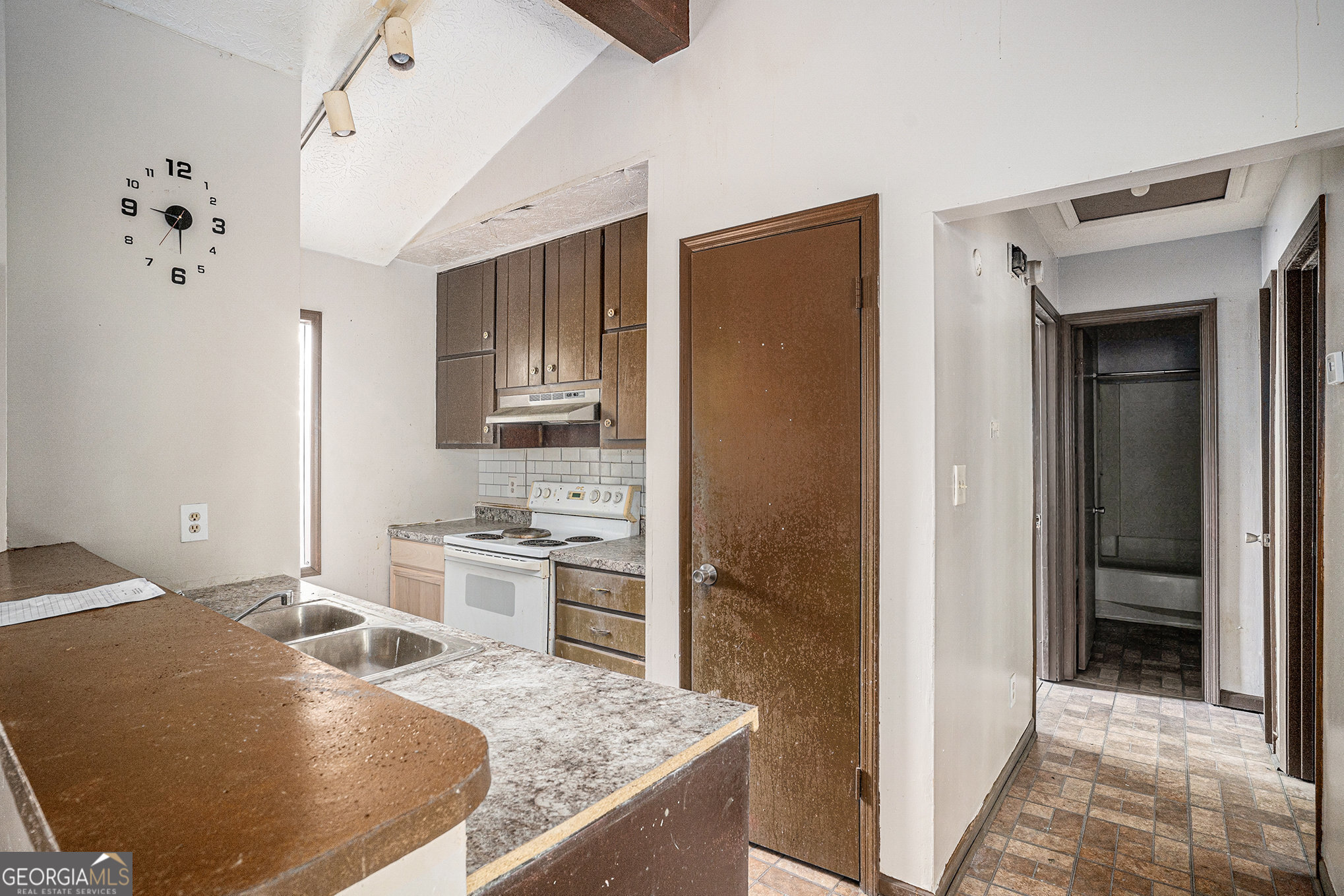 1341 Bethaven Road Riverdale, GA 30296 - Photo 7 of 18 a kitchen with a stove a refrigerator and a sink