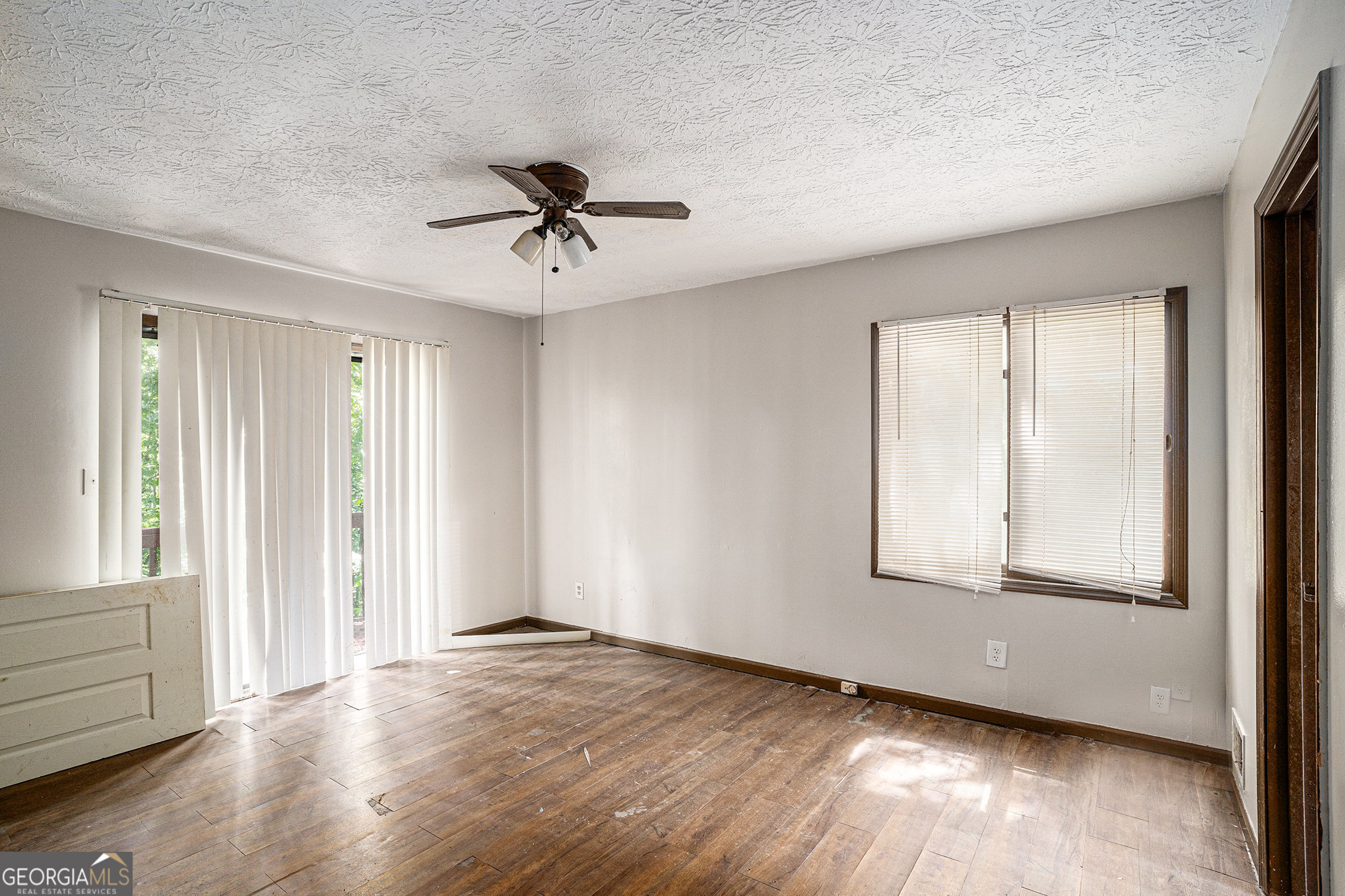 1341 Bethaven Road Riverdale, GA 30296 - Photo 9 of 18 a view of an empty room with wooden floor and a window