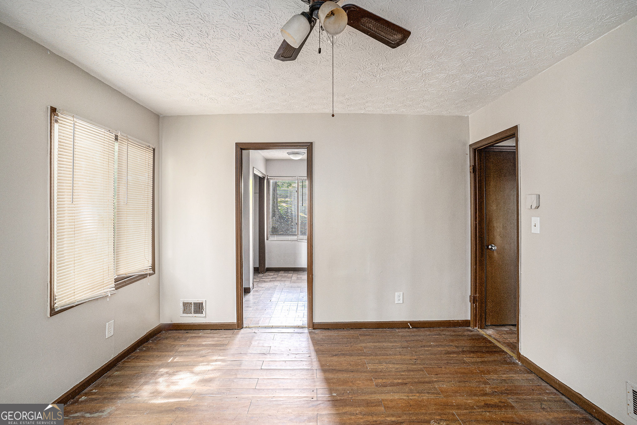 1341 Bethaven Road Riverdale, GA 30296 - Photo 10 of 18 a view of an empty room with window and wooden floor