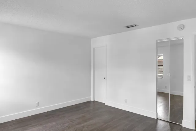 an empty room with wooden floor