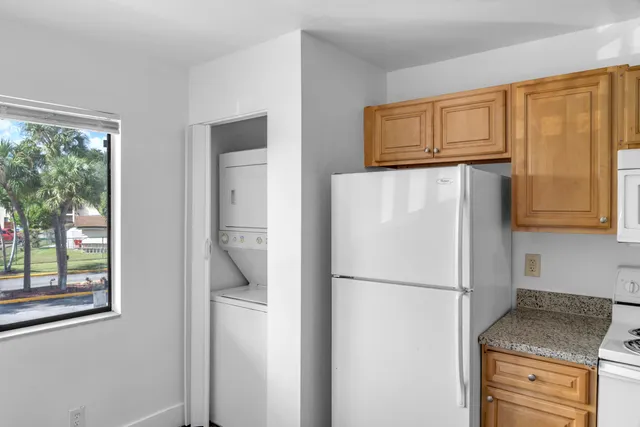 a white refrigerator freezer sitting in a kitchen