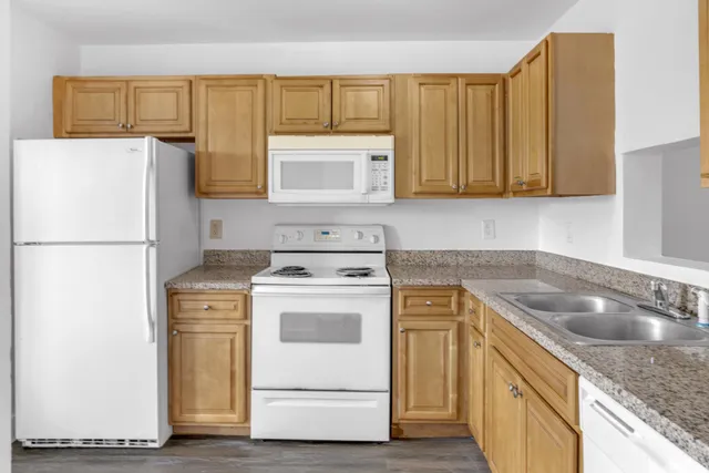 a kitchen with a sink stove and refrigerator