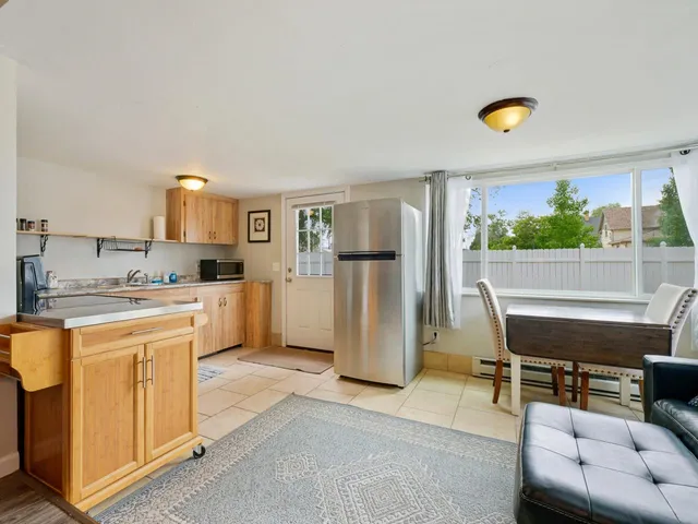 a kitchen with a refrigerator and a stove top oven