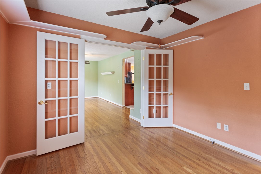202 Keowee Trail Seneca, SC 29672 - Photo 14 of 35 This versatile room features warm wood flooring and elegant French doors, offering flexible living options.