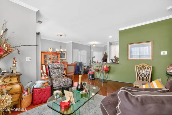 a living room with lots of furniture and a wooden floor