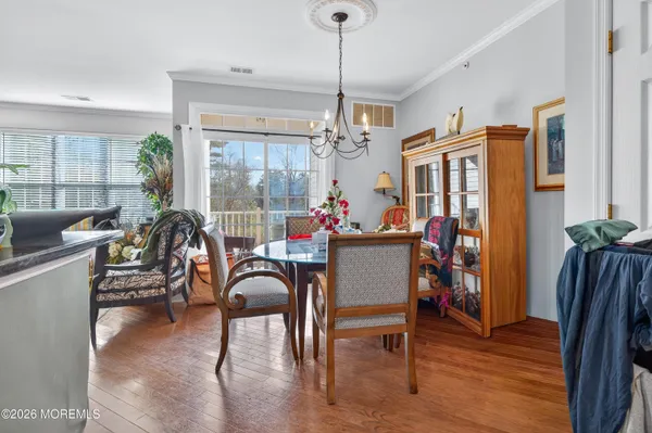 a view of a dining room with furniture window and wooden floor