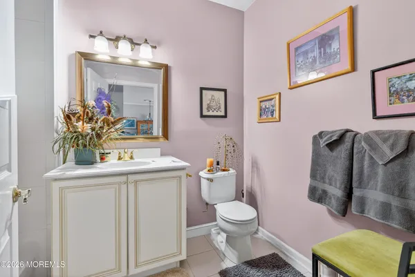 a bathroom with a sink mirror vanity and toilet