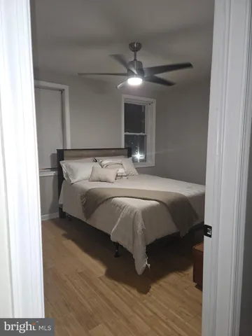 a bedroom with a bed and ceiling fan