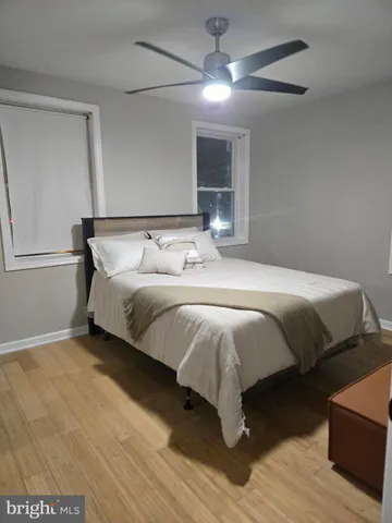 a bedroom with a bed and a mirror