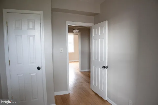 a view of a hallway with wooden floor