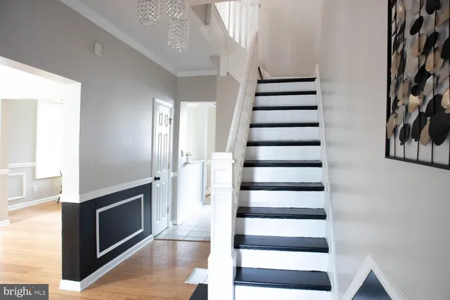 a view of an entryway with wooden floor and stairs