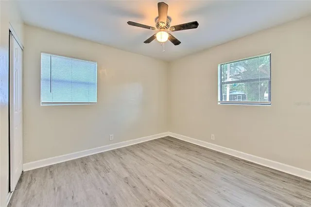 a view of an empty room with wooden floor