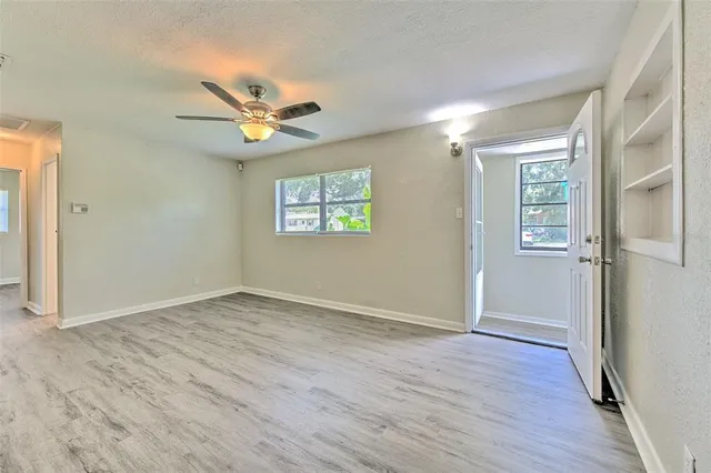 wooden floor in an empty room with a window