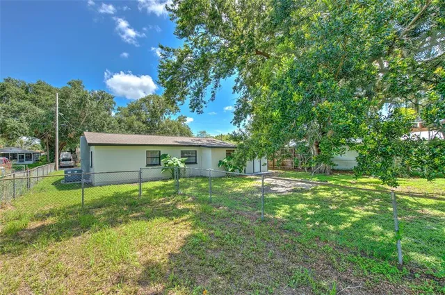 a view of a house with a yard and a patio