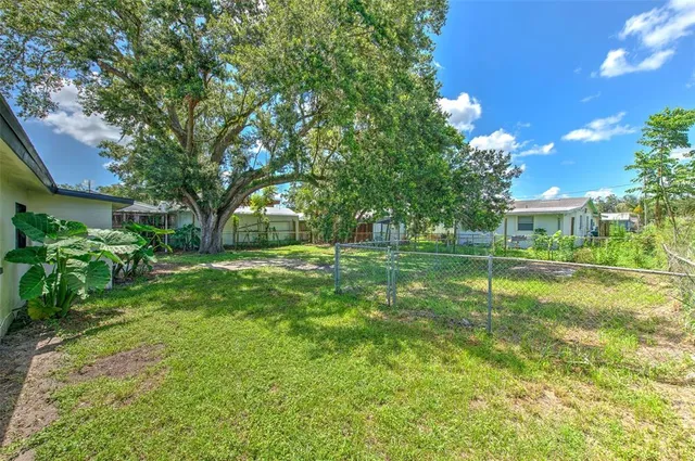a backyard of a house with table and chairs