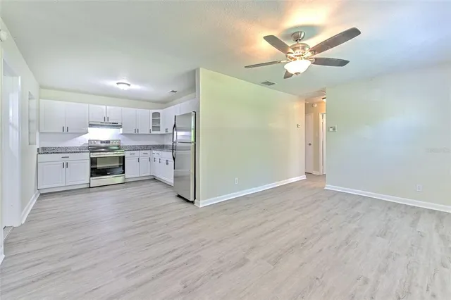 a kitchen with kitchen island a sink and a stove top oven