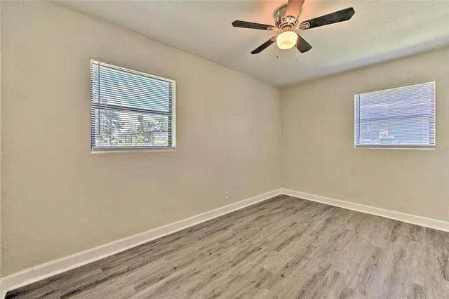 a view of room with hardwood floor and ceiling fan