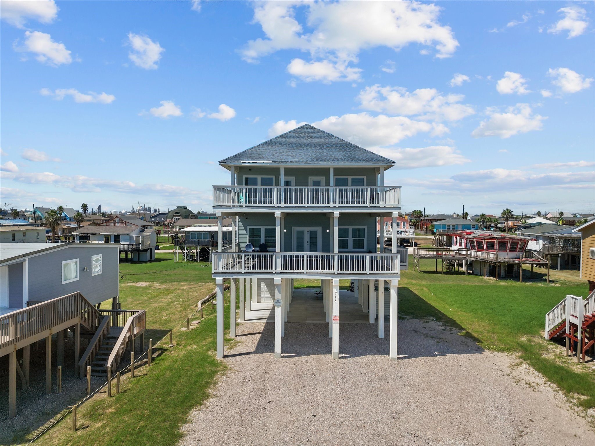 Experience coastal living in this charming elevated beach house, featuring two spacious balconies with stunning views. Enjoy the convenience of an open driveway and relax on the beautifully maintained lawn. Perfect for your seaside retreat.