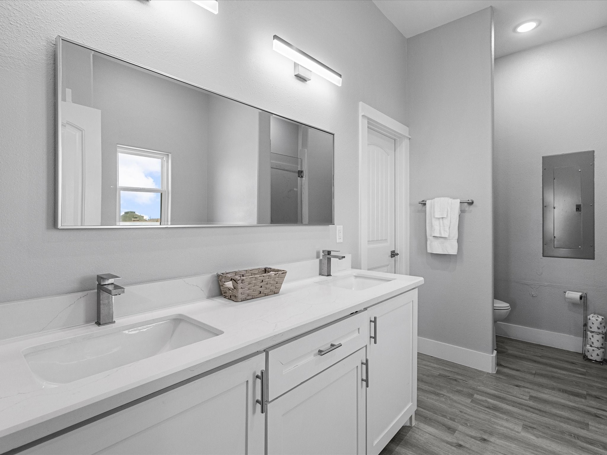 718 Beach Drive Surfside Beach, TX 77541 - Photo 26 of 49 Here's a refined version of your description:
"Enjoy a sleek, modern laundry room with a Samsung washer and dryer, convenient wall-mounted storage, and a stylish door for a clean, functional space.