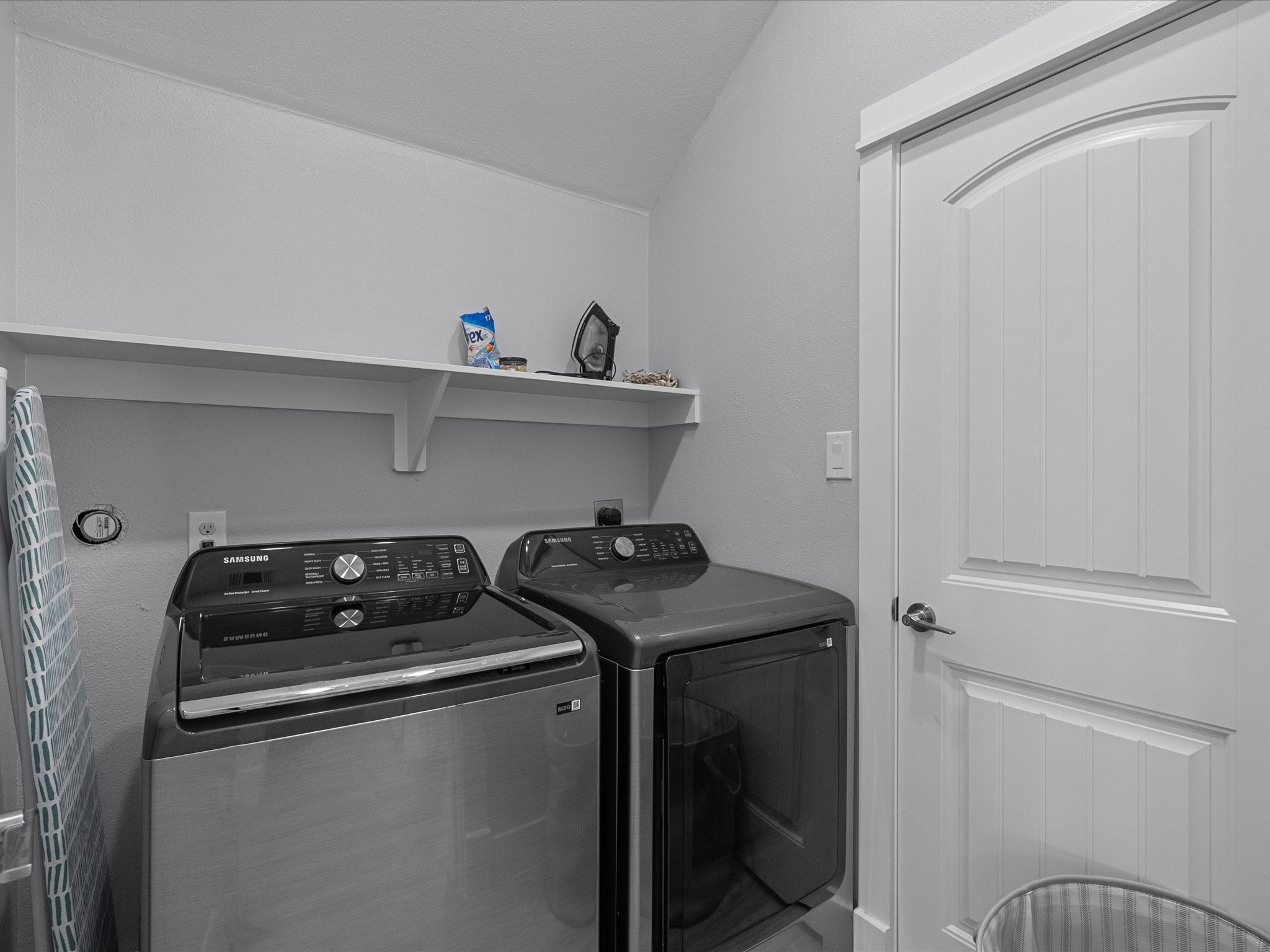 718 Beach Drive Surfside Beach, TX 77541 - Photo 29 of 49 Experience modern elegance in this bathroom with dual sinks, sleek fixtures, and a large mirror. The light color palette flows seamlessly into a bright bedroom with a scenic window view.