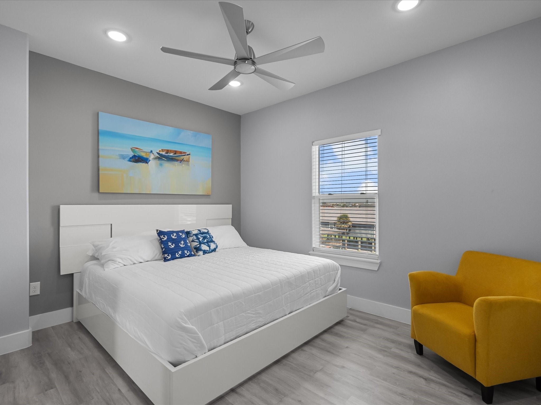 718 Beach Drive Surfside Beach, TX 77541 - Photo 34 of 49 Discover a modern bathroom with a double vanity, large mirrors, and a spacious glass shower. Light gray walls and wood-style flooring offer a sleek, contemporary vibe.