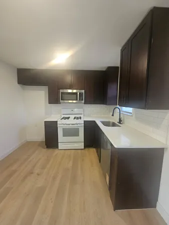 a kitchen with a sink stove and refrigerator