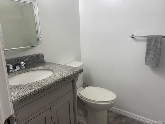 75 Rocky Point Yaphank Road, Unit 133 Rocky Point, NY 11778 - Photo 10 of 15 a bathroom with a granite countertop sink and a toilet