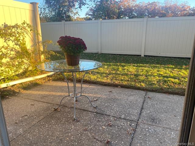 75 Rocky Point Yaphank Road, Unit 133 Rocky Point, NY 11778 - Photo 14 of 15 a backyard of a house with lots of green space and glass windows