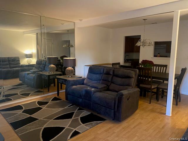 75 Rocky Point Yaphank Road, Unit 133 Rocky Point, NY 11778 - Photo 6 of 15 a living room with furniture a dining table and a piano table