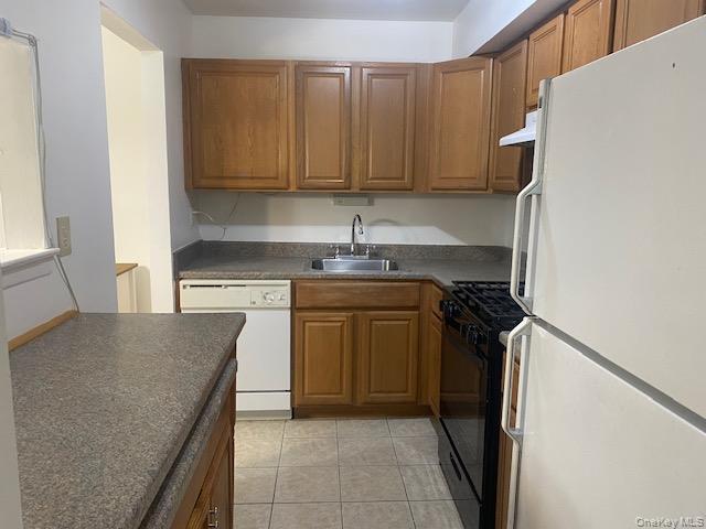 75 Rocky Point Yaphank Road, Unit 133 Rocky Point, NY 11778 - Photo 8 of 15 a kitchen with a stove top oven and cabinets