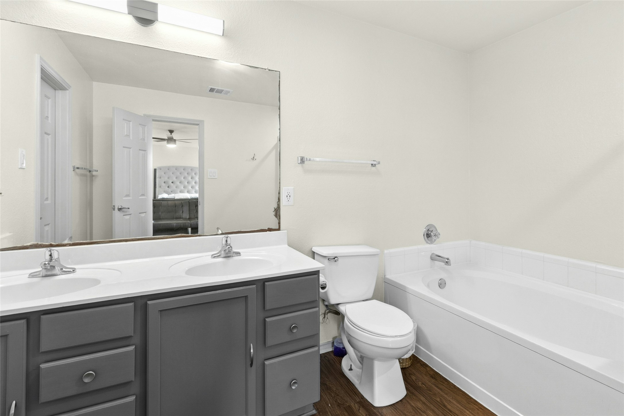 245 Myrtle Street Kyle, TX 78640 - Photo 14 of 24 Master Bathroom with double vanity, a bath, and dark wood finished floors