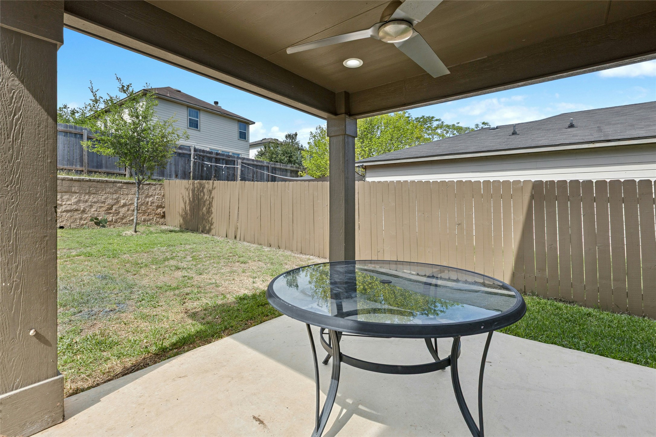 245 Myrtle Street Kyle, TX 78640 - Photo 22 of 24 Fenced backyard featuring a patio and ceiling fan