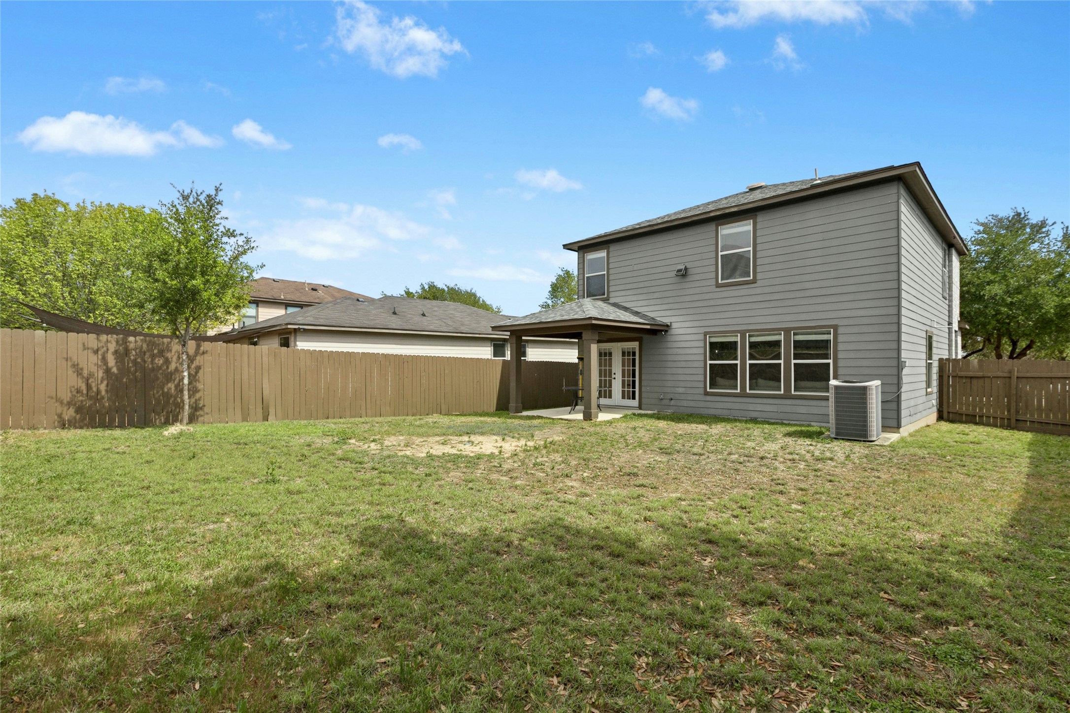 245 Myrtle Street Kyle, TX 78640 - Photo 23 of 24 Back of house featuring a patio area, a fenced backyard, and french doors