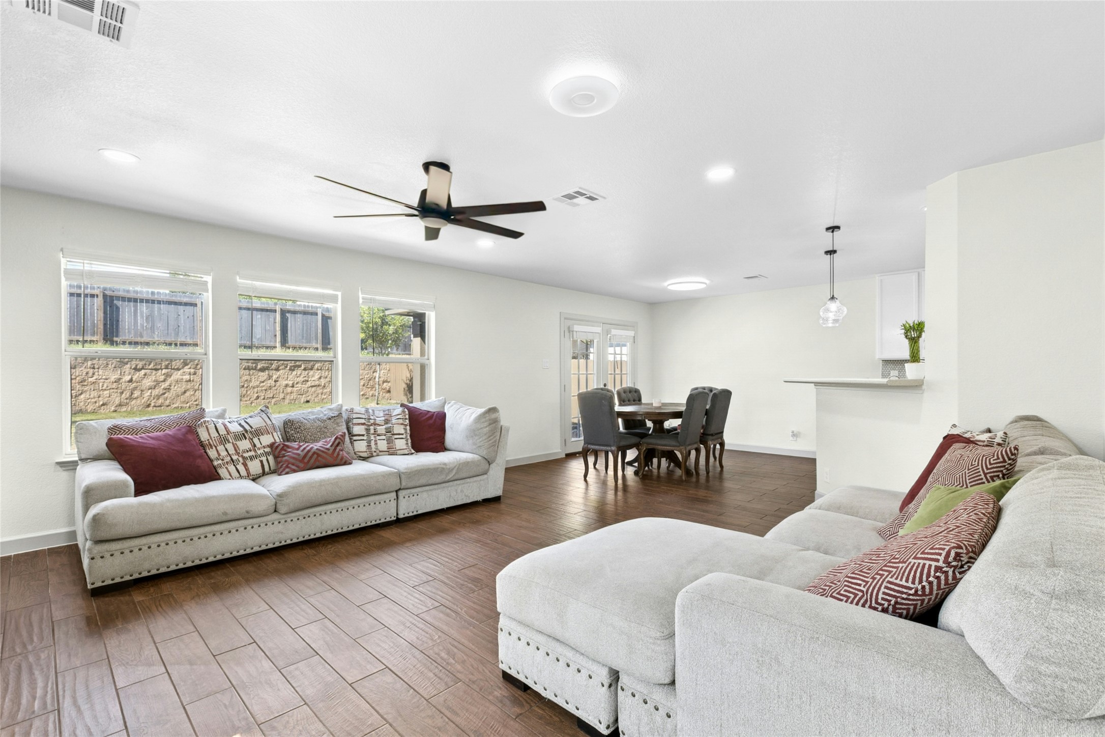 245 Myrtle Street Kyle, TX 78640 - Photo 4 of 24 Living room featuring wood finish floors and a ceiling fan