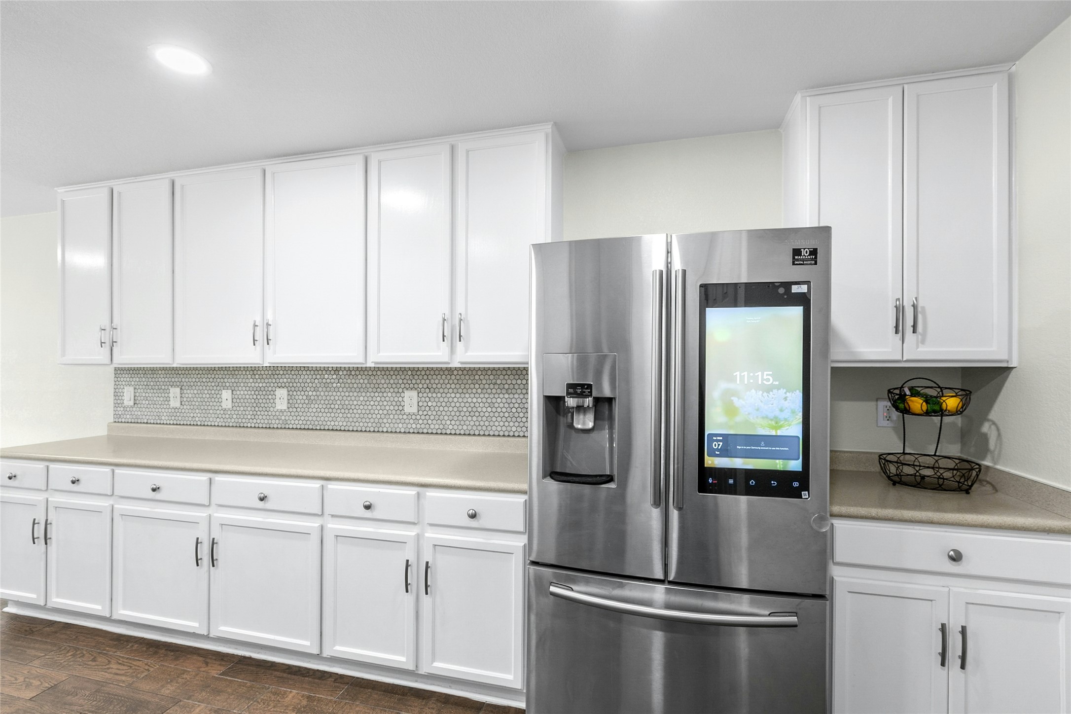 245 Myrtle Street Kyle, TX 78640 - Photo 10 of 24 Kitchen featuring stainless steel fridge with ice dispenser, white cabinetry, and light countertops