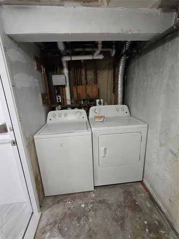 a view of backyard with wooden fence and large trees