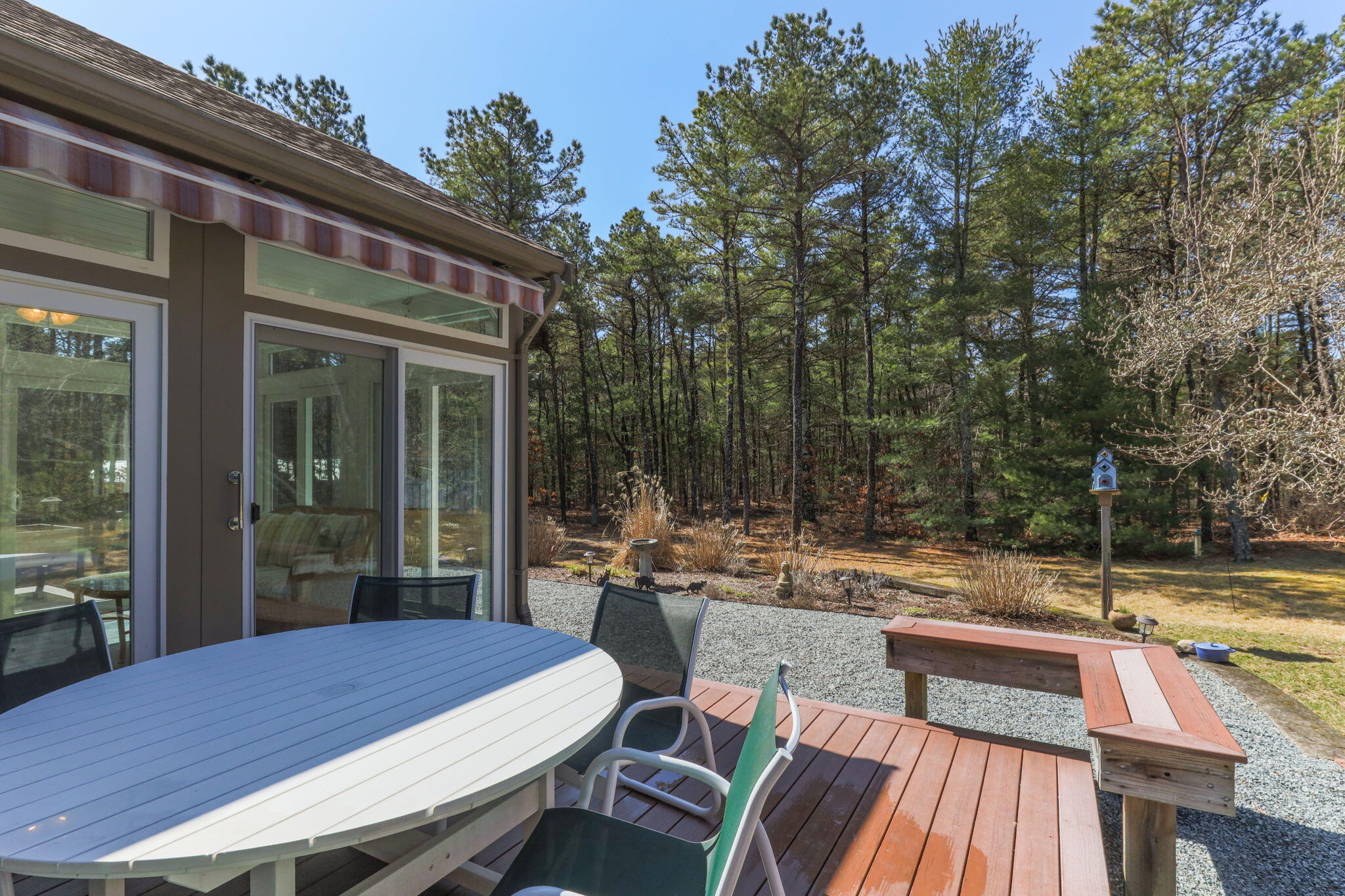 29 Amanda Court Cotuit, MA 02635 - Photo 28 of 45 a view of a patio with table and chairs with wooden floor and fence