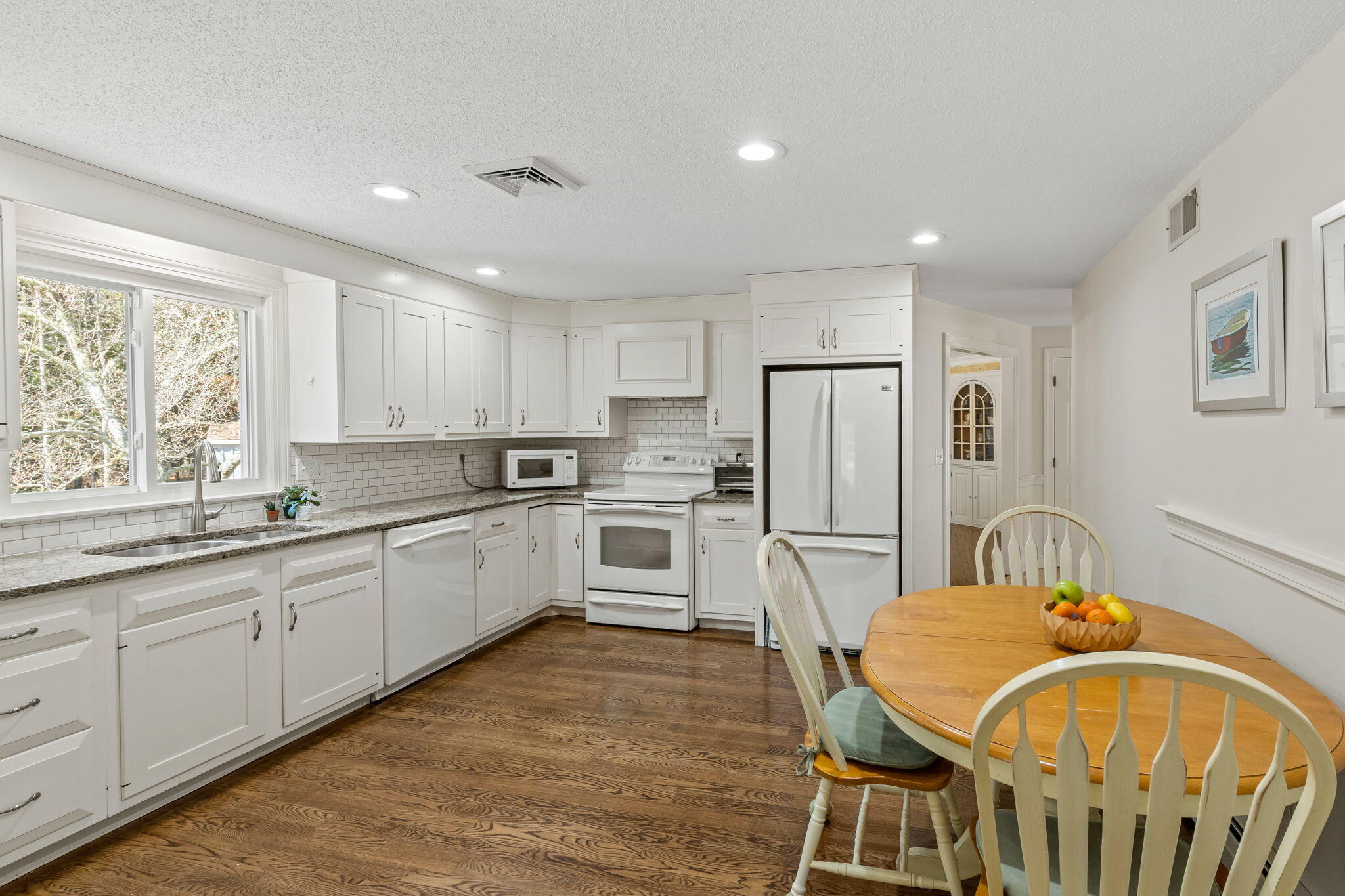 29 Amanda Court Cotuit, MA 02635 - Photo 9 of 45 a kitchen with white cabinets and stainless steel appliances