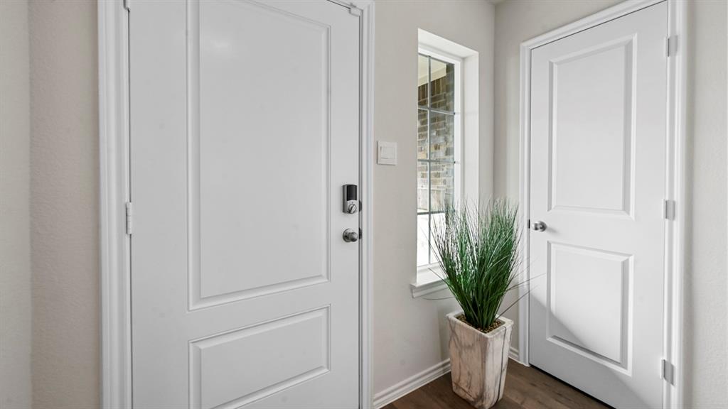 936 Jefferson Way Sherman, TX 75092 - Photo 12 of 31 a view of a hallway with wooden floor and a potted plant