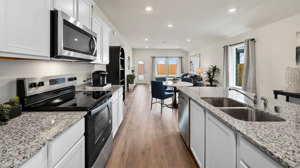 936 Jefferson Way Sherman, TX 75092 - Photo 14 of 31 a kitchen with stainless steel appliances granite countertop a sink stove microwave and cabinets
