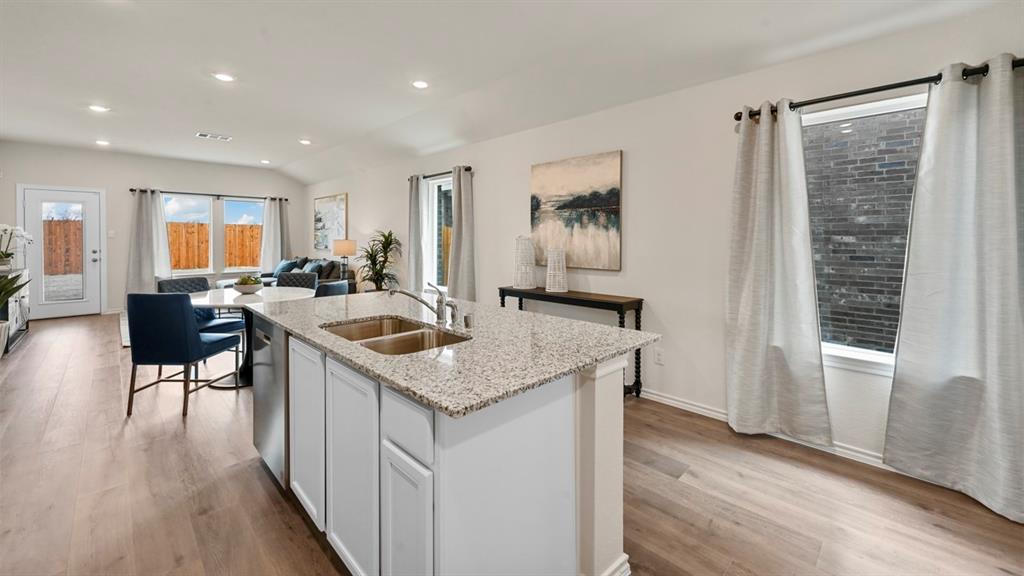 936 Jefferson Way Sherman, TX 75092 - Photo 31 of 31 a kitchen with a sink a stove a refrigerator and wooden floor