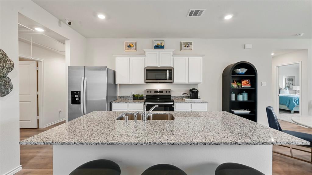 936 Jefferson Way Sherman, TX 75092 - Photo 18 of 31 a kitchen with stainless steel appliances granite countertop a sink refrigerator and microwave