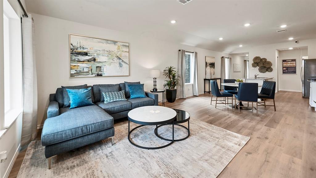 936 Jefferson Way Sherman, TX 75092 - Photo 23 of 31 a living room with furniture and a dining table with wooden floor