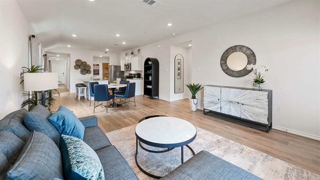 936 Jefferson Way Sherman, TX 75092 - Photo 24 of 31 a living room with furniture a mirror and a chandelier