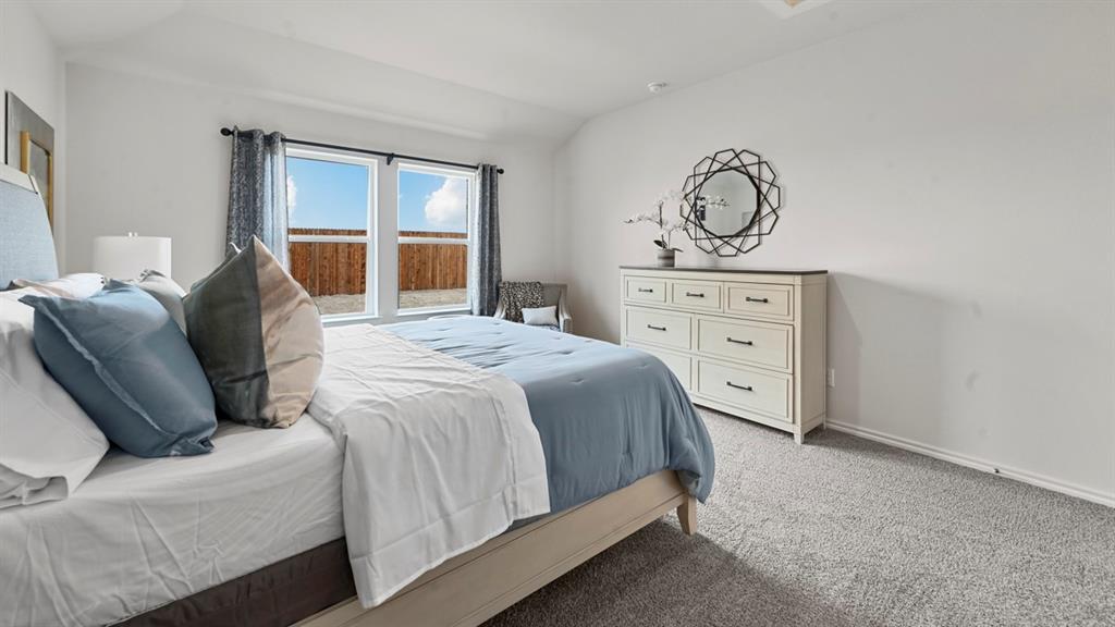 936 Jefferson Way Sherman, TX 75092 - Photo 10 of 31 a bedroom with a bed and ceiling fan