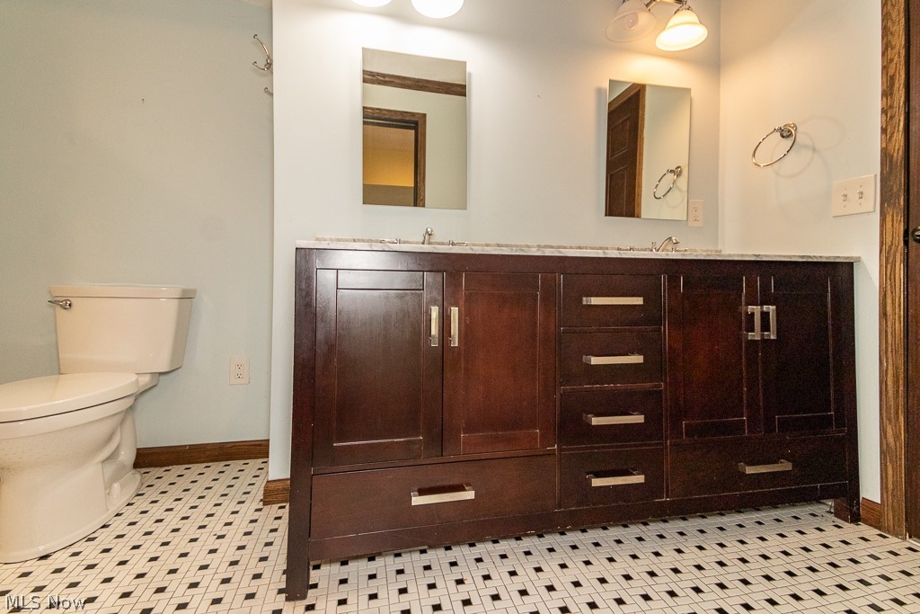 11601 Bass Lake Road Chardon, OH 44024 - Photo 27 of 50 Bathroom with toilet, tile patterned floors, and dual bowl vanity