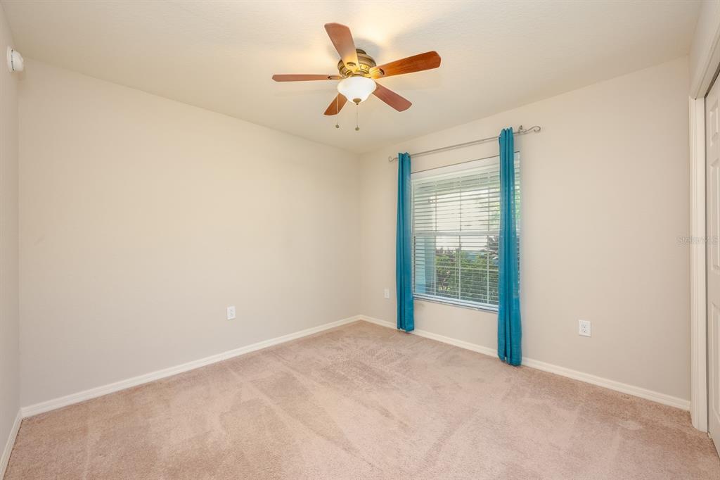 1355 Windward Oaks Loop Auburndale, FL 33823 - Photo 11 of 25 an empty room with fan and windows